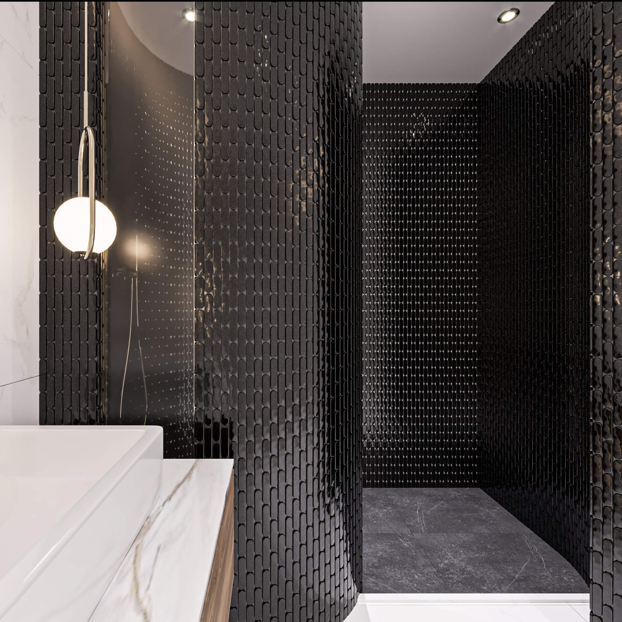 The Sevilla Mosaic Tiles, Oval design in Black, with a size of 23x98mm. Installed on a curved wall shower area within a bathroom. The corner of a vanity unit in front to the left.